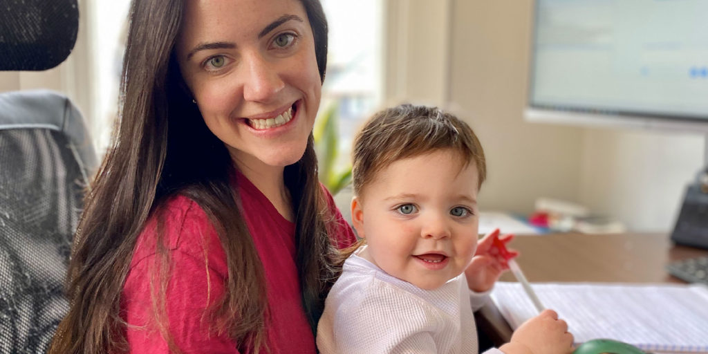 Happy mother and child sitting at a desk while working from home