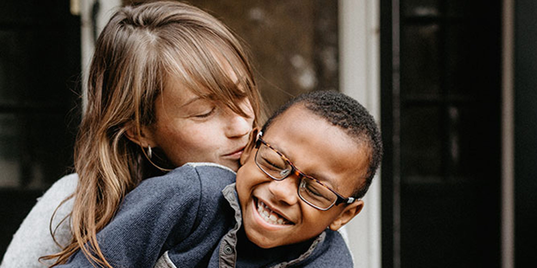 Mother kissing a child laughing