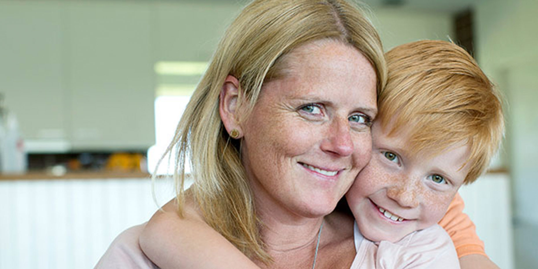 Mother and son smiling at camera