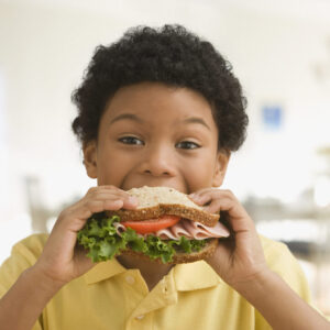 boy eating healthy sandwich