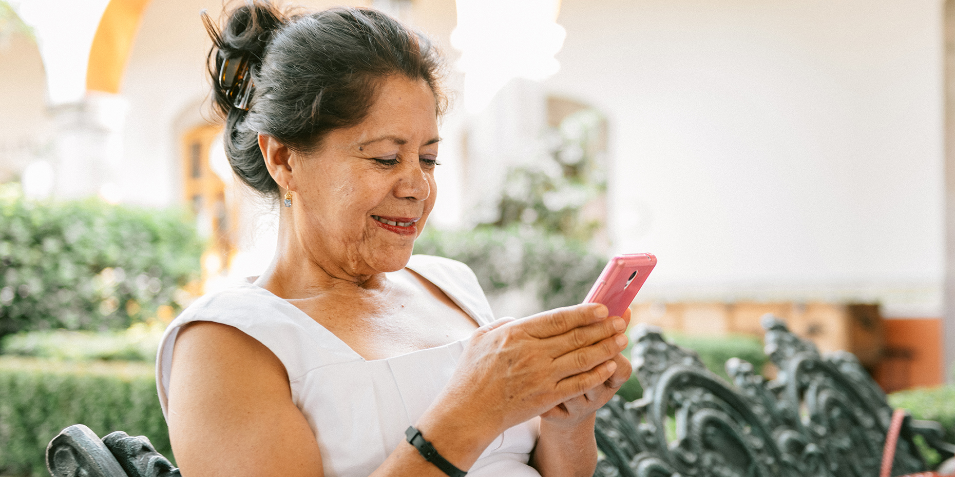 Older woman using a smartphone smiling