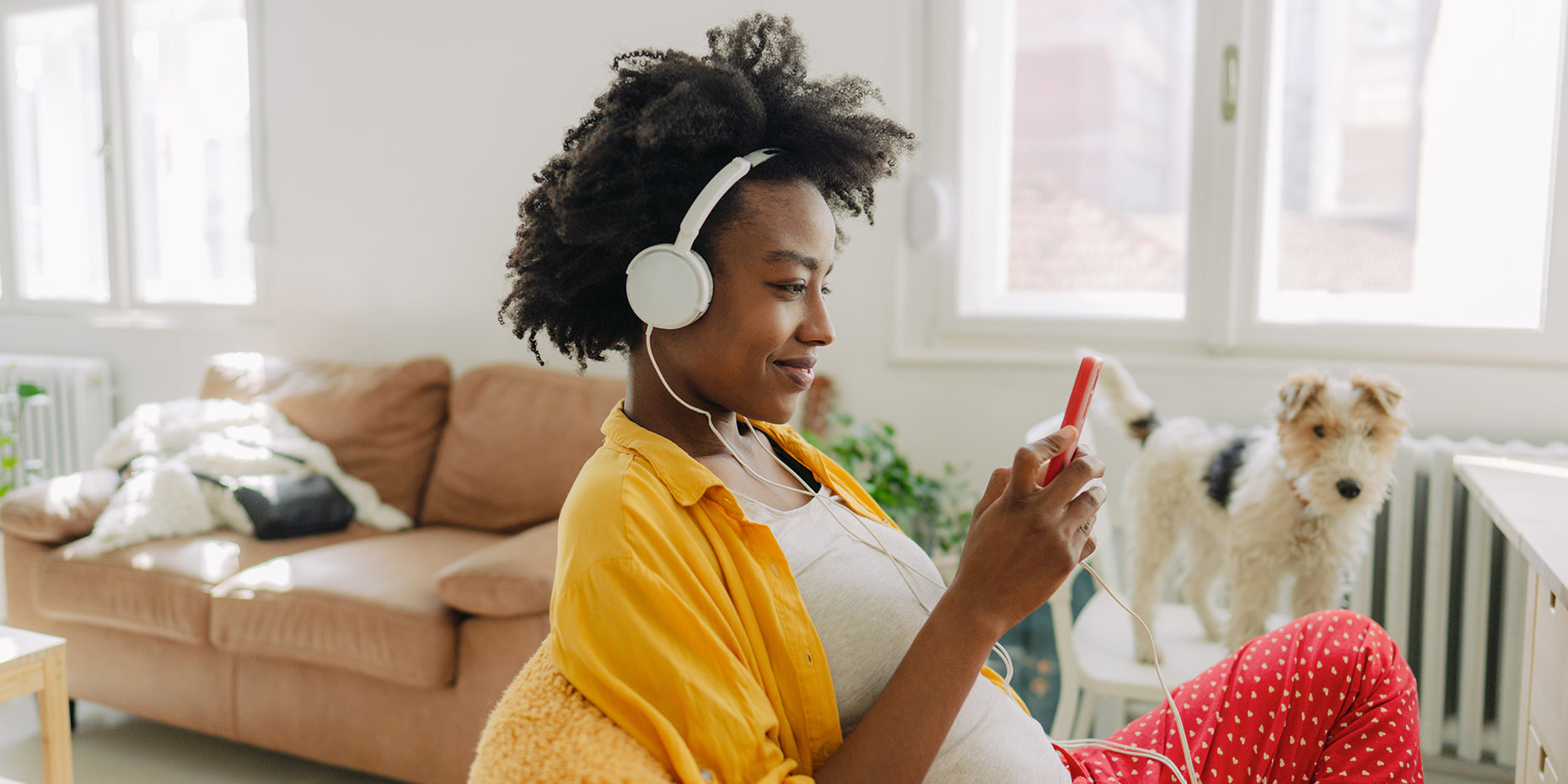 Woman listening to large headphones