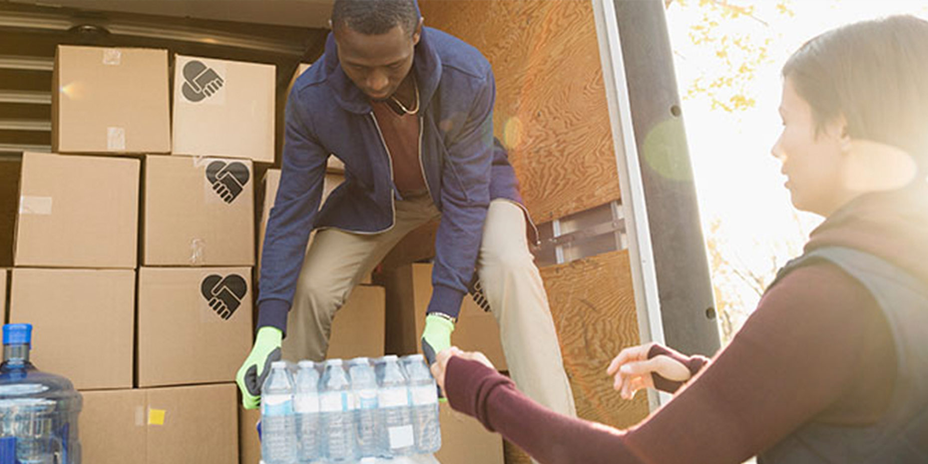 People unloading bottled water from a box truck