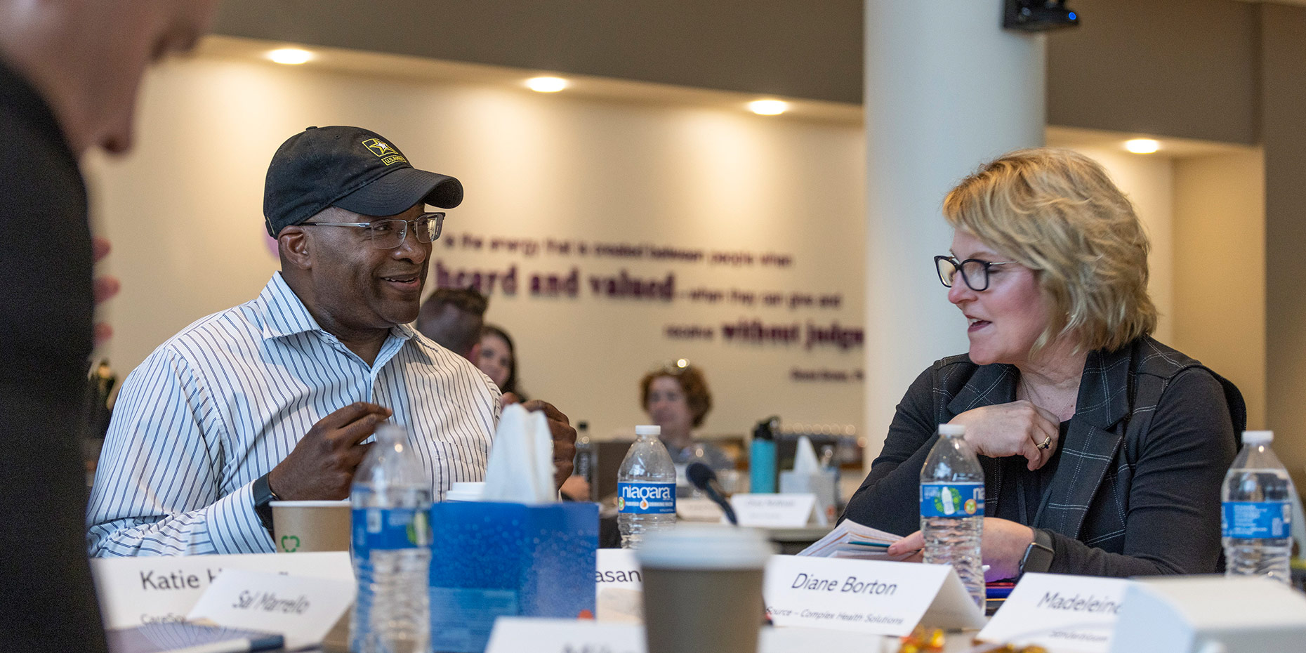 IRH Attendees conversation at the table Newsroom
