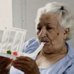 elderly woman using breathing tube