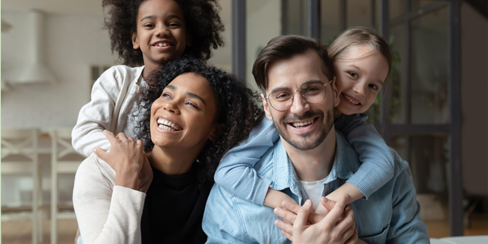 Family laughing together looking at the camera