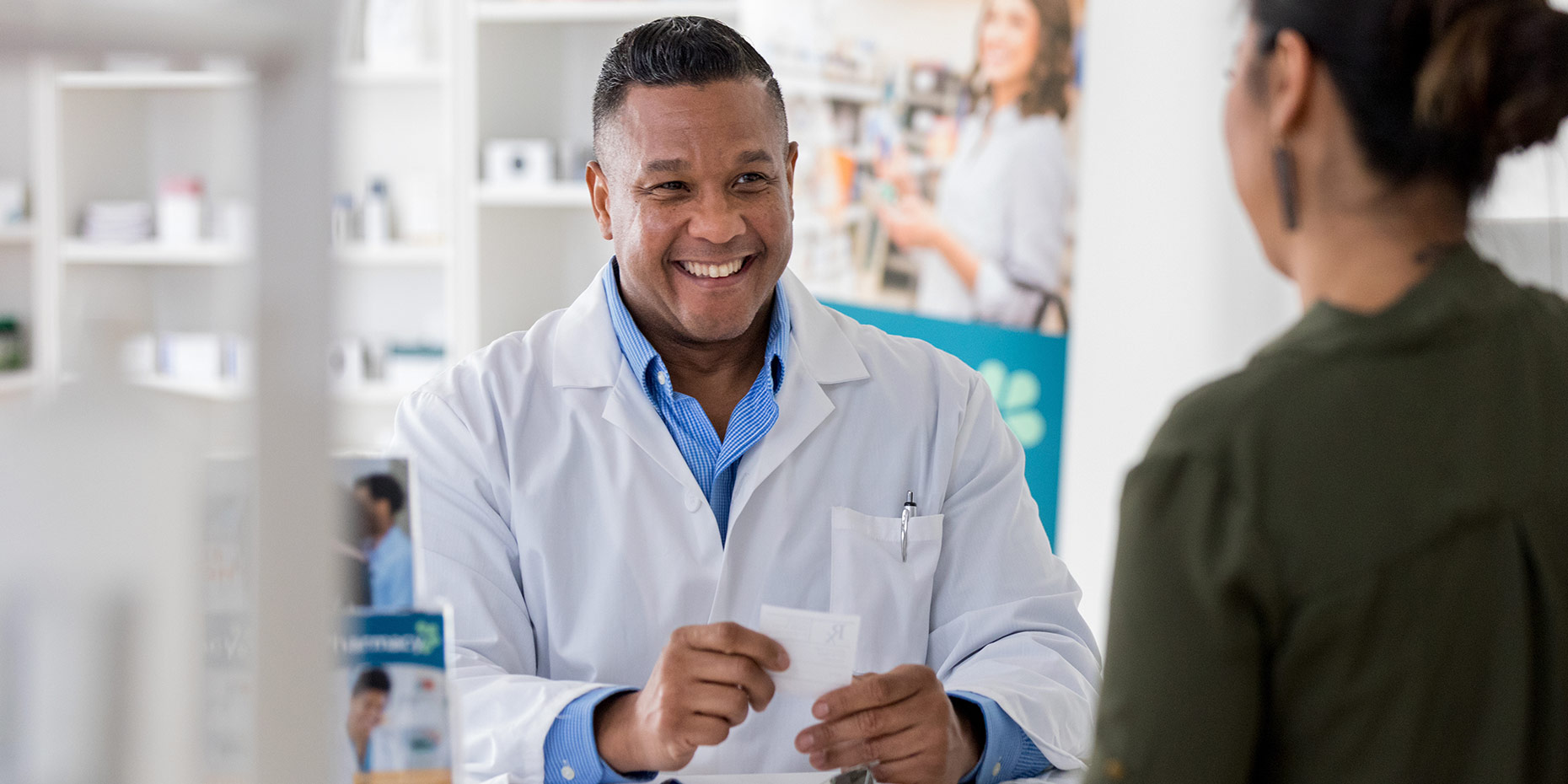 Pharmacist smiling looking at customer