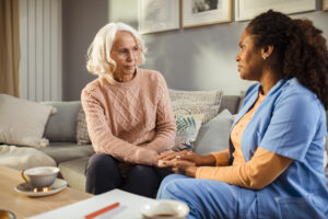 Senior woman talking with her caregiver