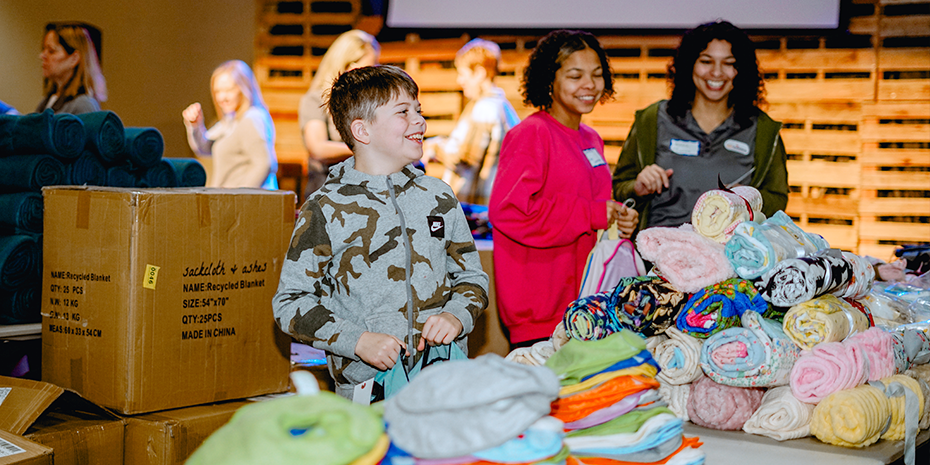 Comfort-cases-volunteers load backpachs for foster children